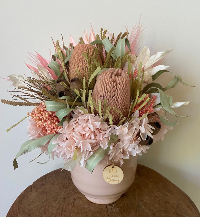 Pink Blush is created using dried, preserved and faux flowers and displayed in a pink ceramic pot. It's soft tones of pinks, green and white will add a gentleness to any room in the home or office. Approx size is 35cm x 25cm including pot. Sutherland Shire Delivery. Sydney wide delivery. Australia wide delivery.