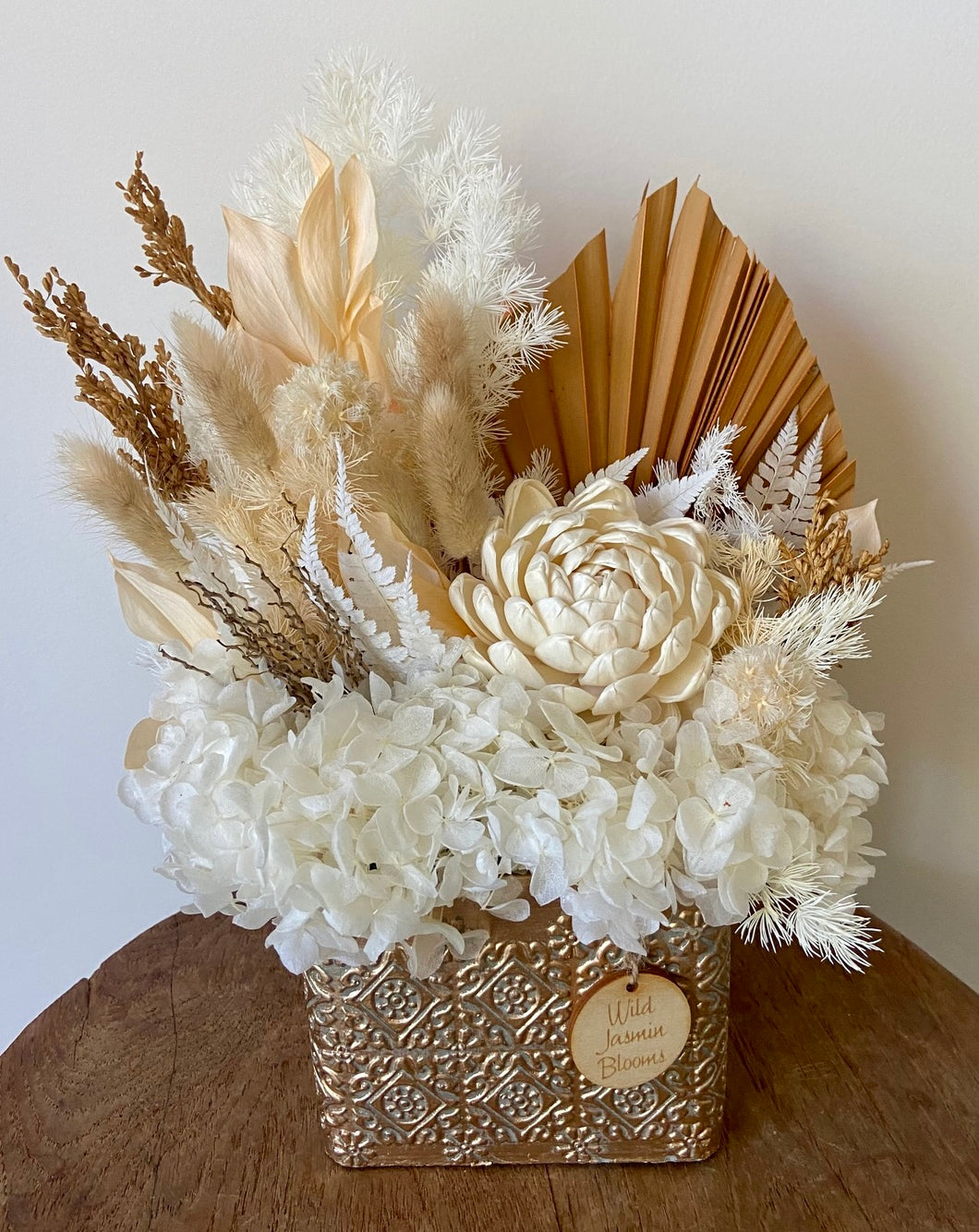 Golden Moments is created using dried, preserved and faux flowers and displayed in a gold patterned pot.  It's classic tones of gold, browns and white will add a warming touch to any room in the home or office. Approx size is 30cm x 25cm including pot. Sutherland Shire delivery. Sydney wide delivery. Australia wide delivery.