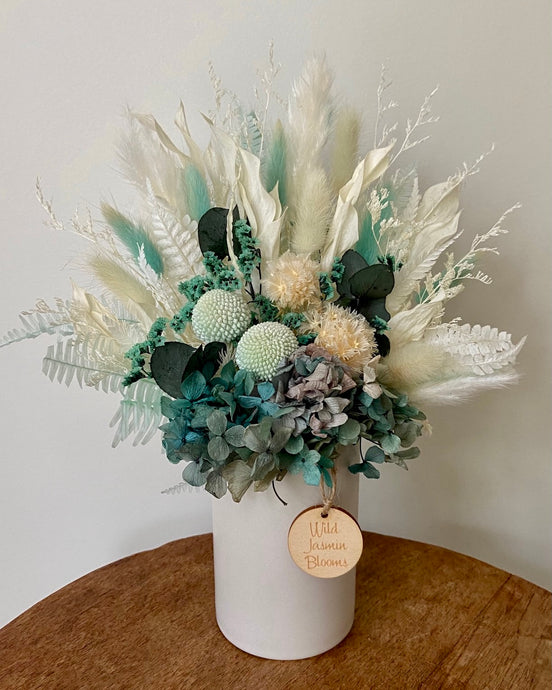 Carribean is created using dried, preserved and faux flowers and displayed in a ceramic pot. It's striking tones of teal will light up any room, home or office. Approx size is 28cm x 20cm including pot. Sutherland Shire delivery. Sydney wide delivery. Australia wide delivery.