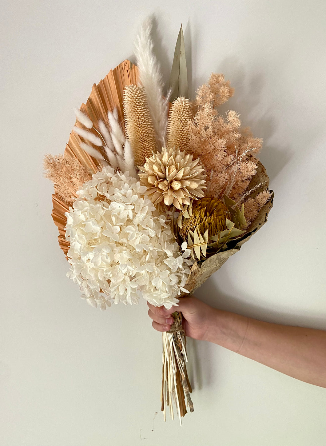 Wild Apricot Lotus Wrap is created using dried, preserved and faux flowers. This bouquet comes gift wrapped with a ribbon and can be displayed laid down or popped into a vase. Approx length is 60cm including stems. Sutherland Shire Delivery. Sydney Delivery. Australia wide delivery.