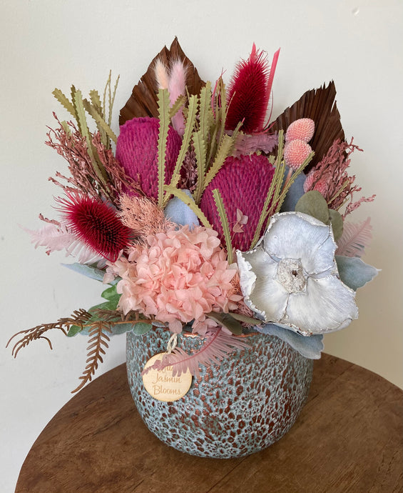 Pink Charm is a dried, preserved and faux flower arrangement displayed in an unusual patterned concrete pot. Its compact style makes a gorgeous side table display for home, office or even hospital and Nursing Home. Approx size is 30cm x 30cm including pot. Sutherland shire flower delivery, Sydney flower delivery, Australia wide flower delivery.