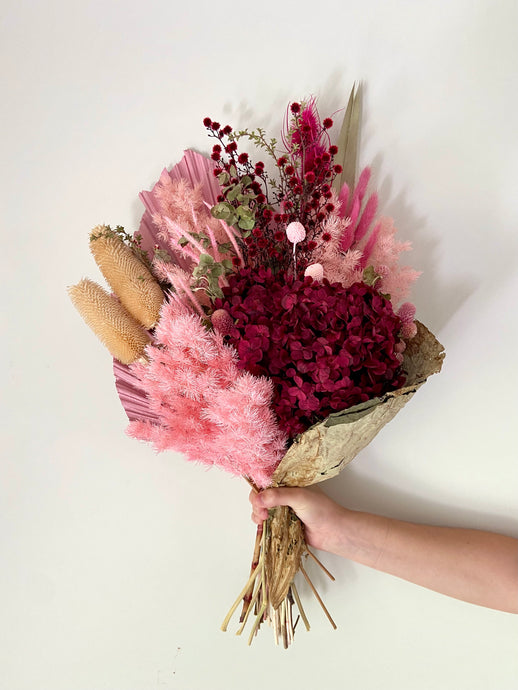 Crimson Lotus Wrap is created using dried, preserved and faux flowers. This bouquet comes gift wrapped with a ribbon and can be displayed laid down or popped into a vase. Approx length is 60cm including stems. Sutherland Shire Delivery. Sydney Delivery. Australia wide delivery.