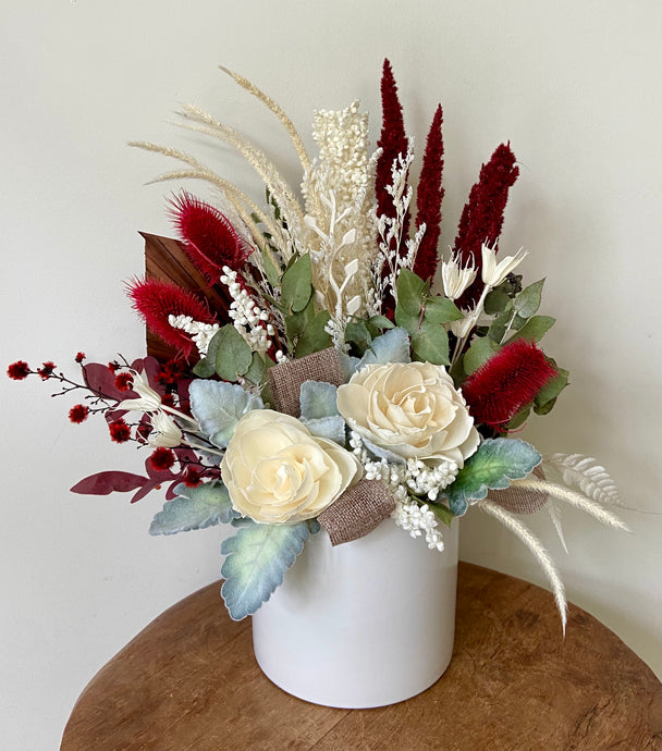 Scarlet is created using dried, preserved and faux flowers and displayed in a white ceramic pot. Perfect for the lovers of red! Approx size is 35cm x 30cm. Sutherland Shire delivery. Sydney delivery. Australia wide delivery.