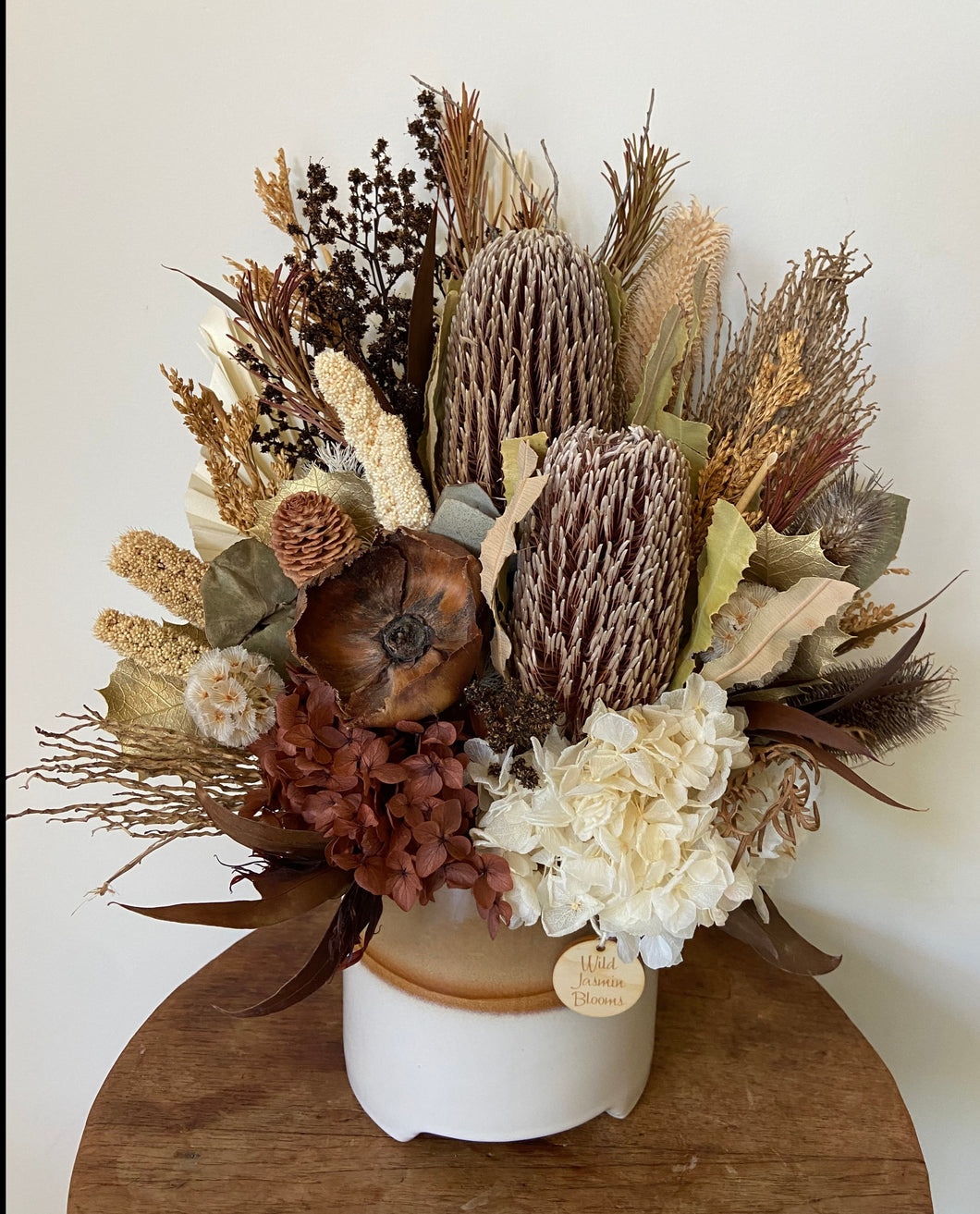 Bush Walk is created with dried, preserved and faux flowers and is displayed in a two tone ceramic pot. Its earthy tones and blooms reminds me of those early morning bush walks! This natural beauty is an arrangement for all occasions and can be displayed anywhere.. Approx size is 35cm x 45cm including pot. Delivery Sutherland Shire. Delivery Sydney. Delivery Australia. Dried Flowers.