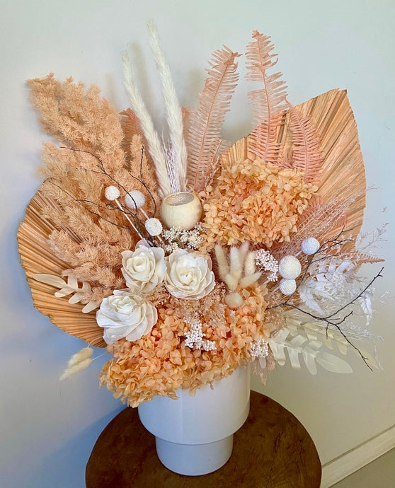Tangerine is created using dried, preserved and faux flowers and displayed in a white tapered pot. This is a large arrangement in apricot and white and would look perfect in any boho styled home or office. Approx size is 60cm x 45cm including pot. Sutherland Shire Delivery.