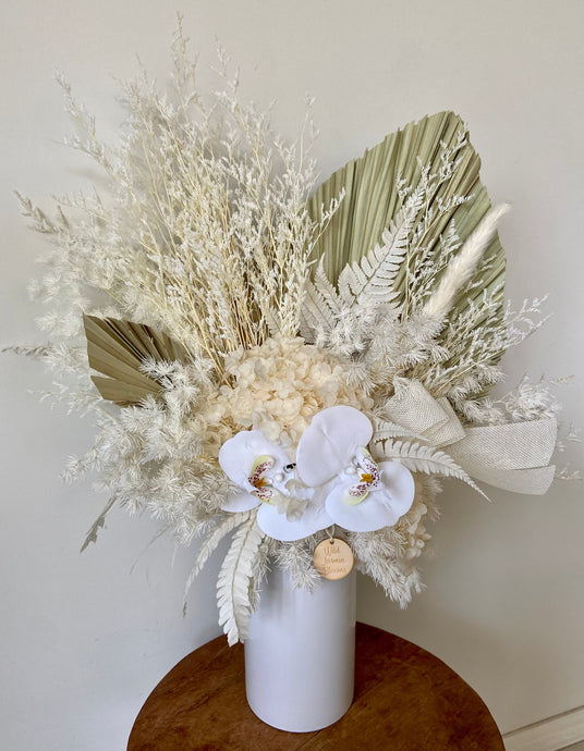 Orchid Fairy is a dried, preserved and faux flower arrangement displayed in a ceramic vase. This statement piece is perfect for an entry display in home or office and makes a gorgeous gift! Approx size is 50cm x 60cm including vase. Sutherland Shire flower delivery, Sydney Flower delivery, Australia wide Flower Delivery. Dried flower delivery.