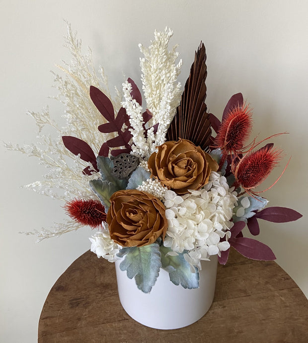 Desert Dusk is created with dried, preserved and faux flowers. It is displayed in a white ceramic pot. This mini pot is a cute little display for anywhere. Great size for a bedside table, lamp or hall table. Really great size for Nursing Homes and Hospitals too. Approx size is 30cm x 25cm. Dried flowers Sutherland shire. Dried flowers Sydney. Dried flower arrangements Australia wide. Custom dried flower arrangements available.