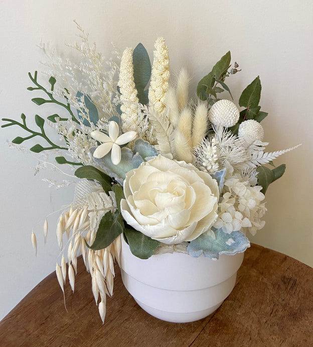 Mini Winter Garden is created using dried, preserved and faux flowers and displayed in a white ceramic pot.  This cute little mini makes a lovely gift and is also perfect for Nursing Homes and Hospitals. Approx size is 25cm x 22cm including pot. Sutherland Shire Delivery. Sydney Delivery. Australia wide Delivery.