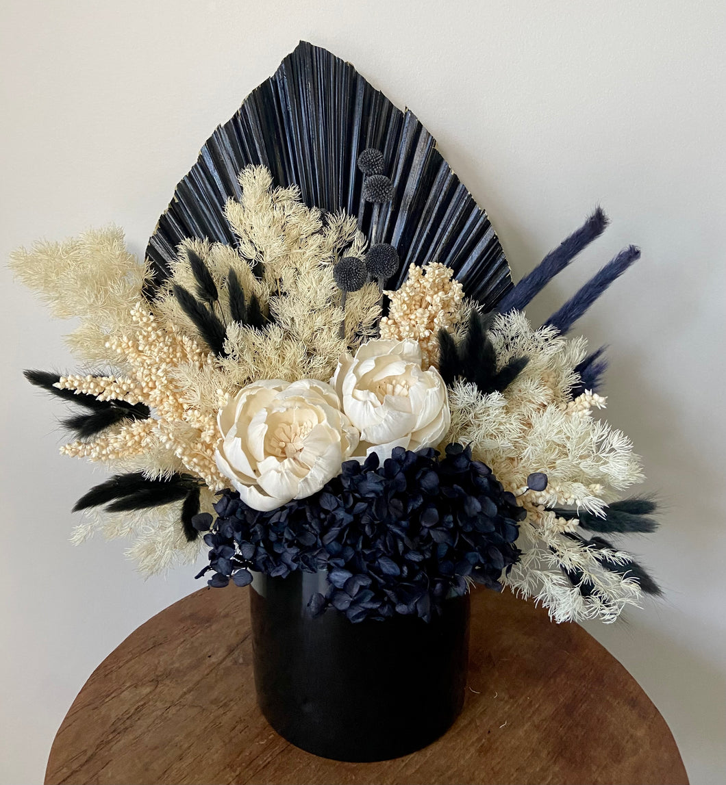 Dark Night is created using dried, preserved and faux flowers and comes displayed in a black ceramic pot. This bold arrangement can be displayed anywhere throughout the house or office and would add a striking statement. Approx size is 40cm x 40cm including the pot. Sutherland Shire Delivery. Sydney wide delivery. Australia wide delivery.