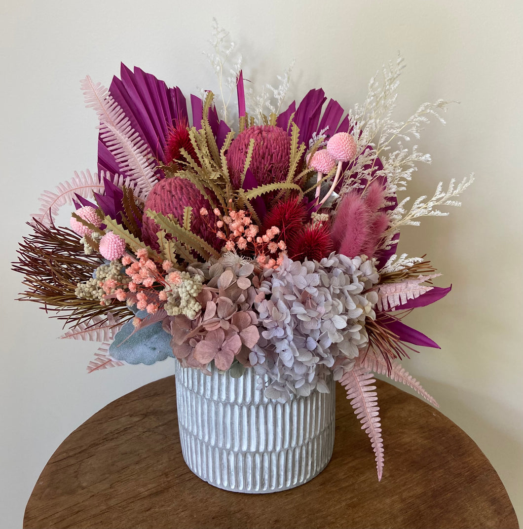 Mulberry is a dried, preserved and faux flower arrangement displayed in a stylish ribbed concrete pot. Its compact style makes a gorgeous side table display for home, office or even hospital and Nursing Home. Approx size is 35cm x 30cm including pot. Sutherland Shire delivery. Sydney wide delivery. Australia wide delivery.