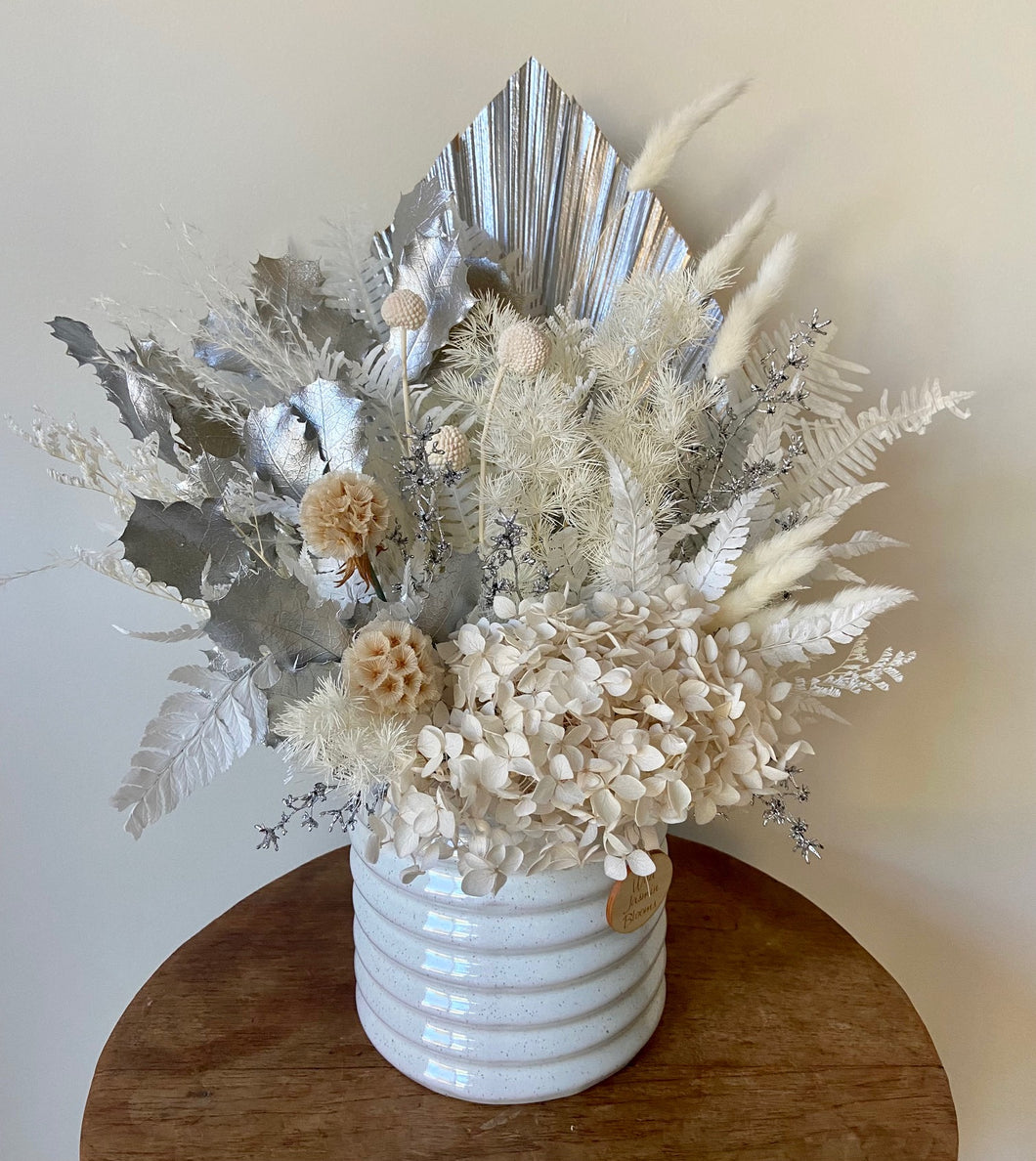 Stargaze is created using dried, preserved and faux flowers and is displayed in a ribbed ceramic pot. This silvery beauty will add glimmer to any room be home or office. Approx size is 45cm x 35cm including pot. Sutherland Shire Delivery. Sydney Wide Delivery. Australia Wide Delivery.