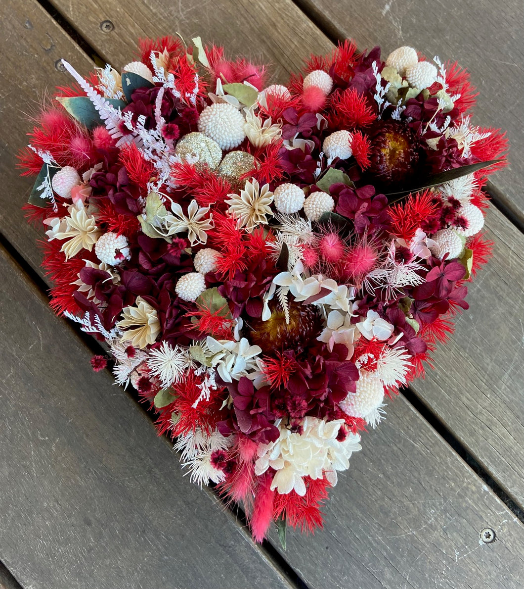 Devine is a floral heart created using dried, preserved and faux flowers. It can be displayed laid flat on a table or hung up as a wall piece. Approx size is 30cm x 28cm. Sutherland Shire Delivery. Sydney wide delivery. Australia wide delivery.