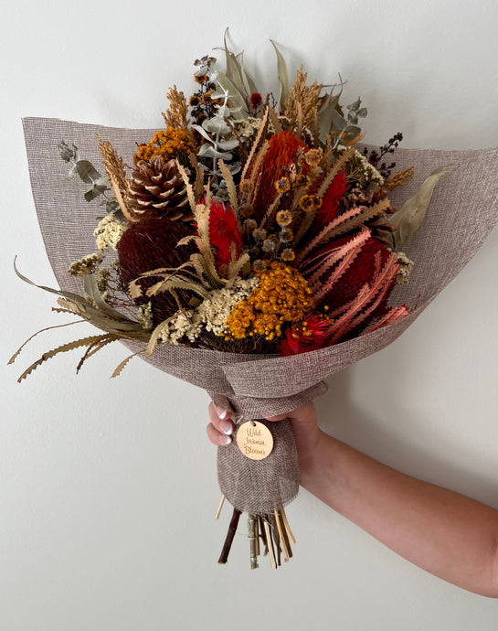 Ruby bouquet is created using dried, preserved and faux flowers. These are great for any occasion and work great in both the home or office. It can be displayed laid along a sideboard, table etc or displayed upright in a vase. Approx length is 45cm including stems. Sutherland Shire Delivery. Sydney wide delivery. Australia wide delivery.