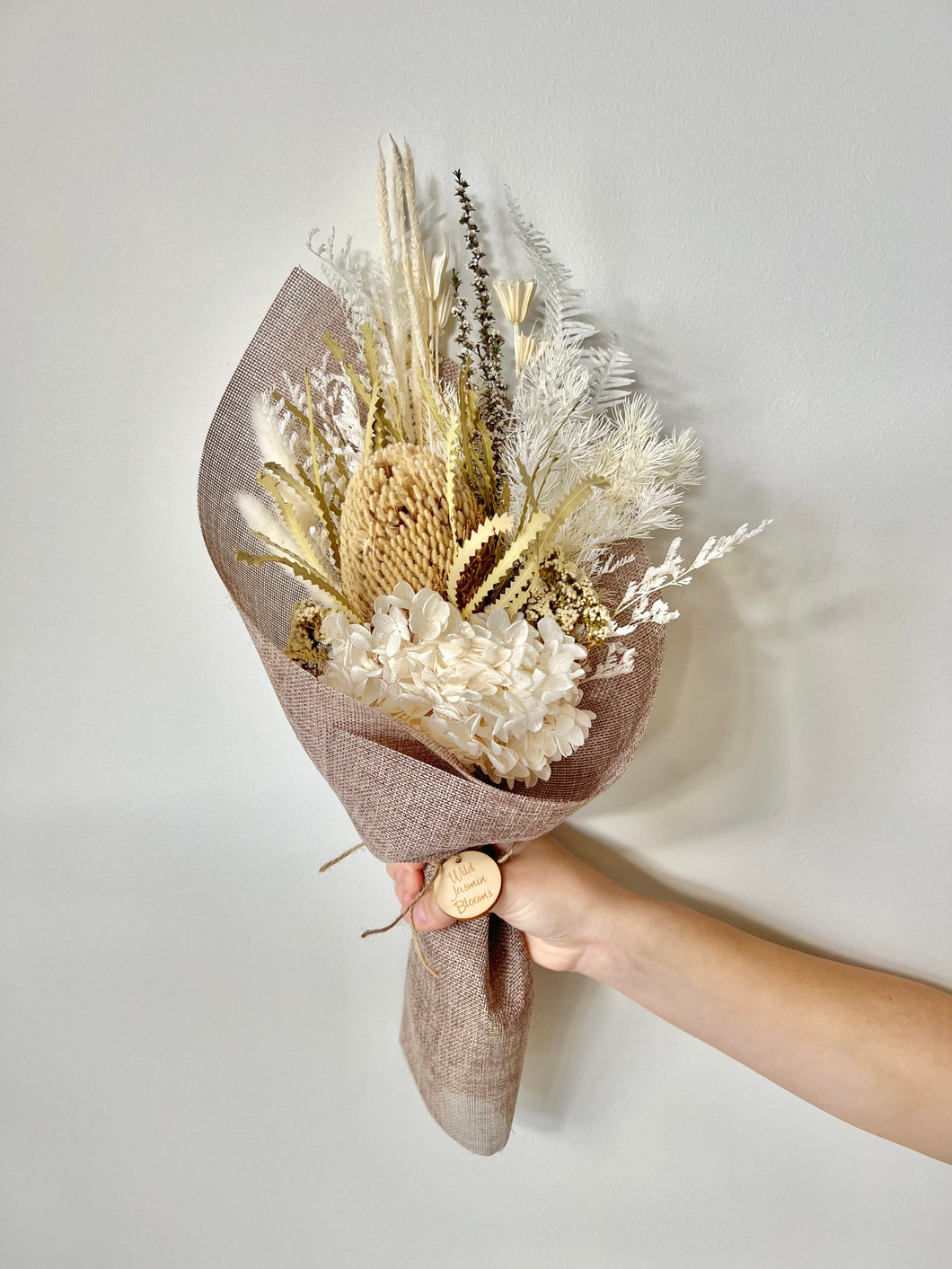 Coconut Cream Posy is created using dried, preserved and faux flowers. This posy comes gift wrapped and can be displayed laid down or popped into a small vase. Approx length is 40cm including stems. Sutherland Shire delivery. Sydney wide Delivery. Australia wide delivery.